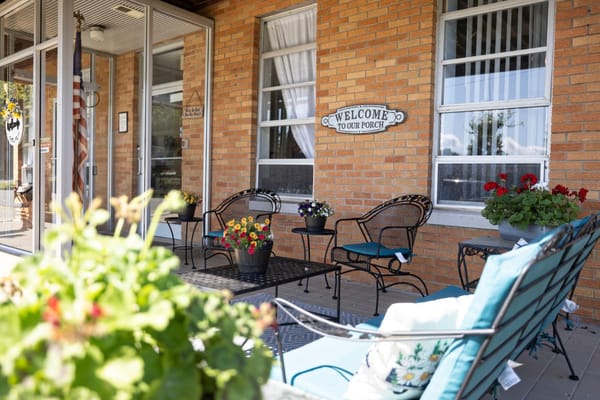 Welcoming interior porch area with seating and flowers