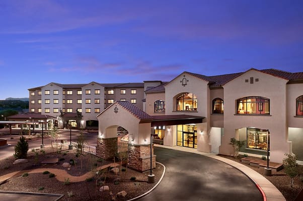 Exterior view of a senior living facility at dusk