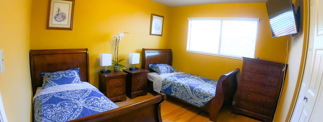 Private resident room with two beds and warm decor