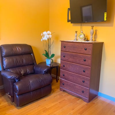 Comfortable armchair and dresser in a resident's room
