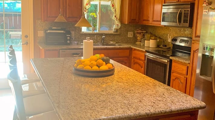 Modern kitchen with granite countertops and fruit bowl