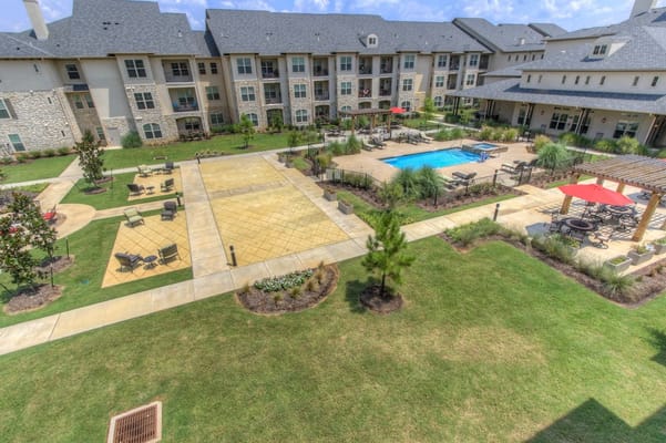 View of a landscaped pool area in a senior living facility
