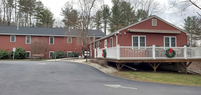Red exterior of Assisted Living facility with winter decorations