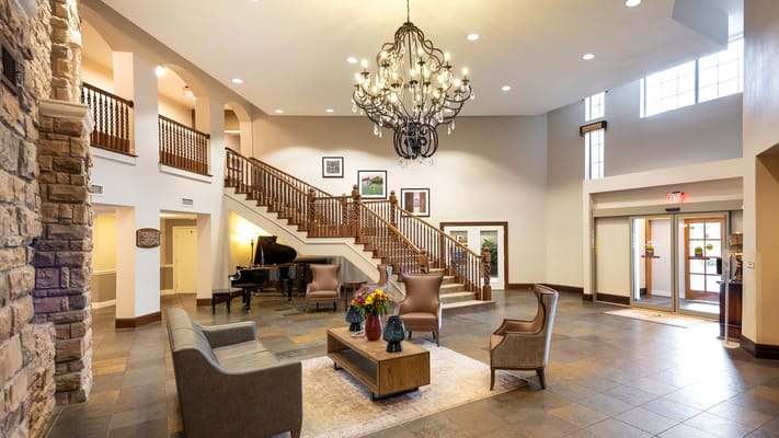 Common area with seating and piano in a spacious lobby