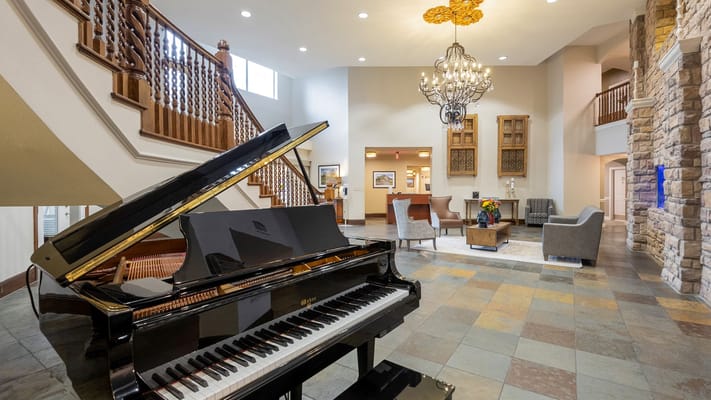 Elegant common area with piano and chandelier