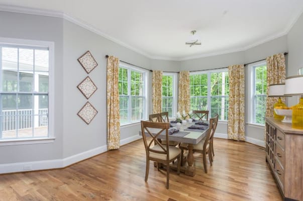Bright dining area with large windows and stylish decor