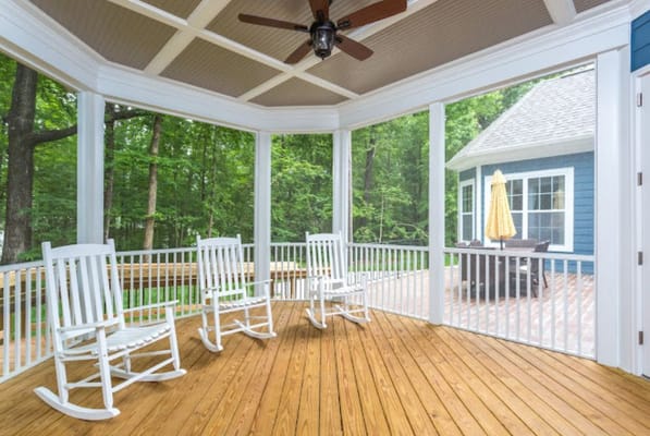 Screened porch area with rocking chairs