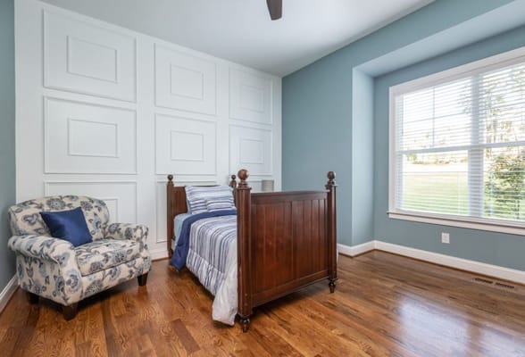 Private resident room with a bed and chair