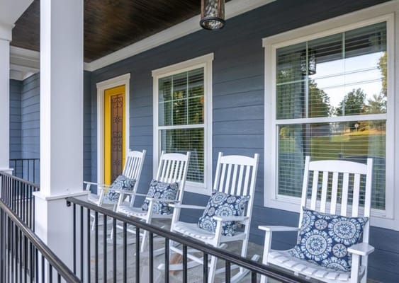 Rocking chairs on a porch with decorative cushions