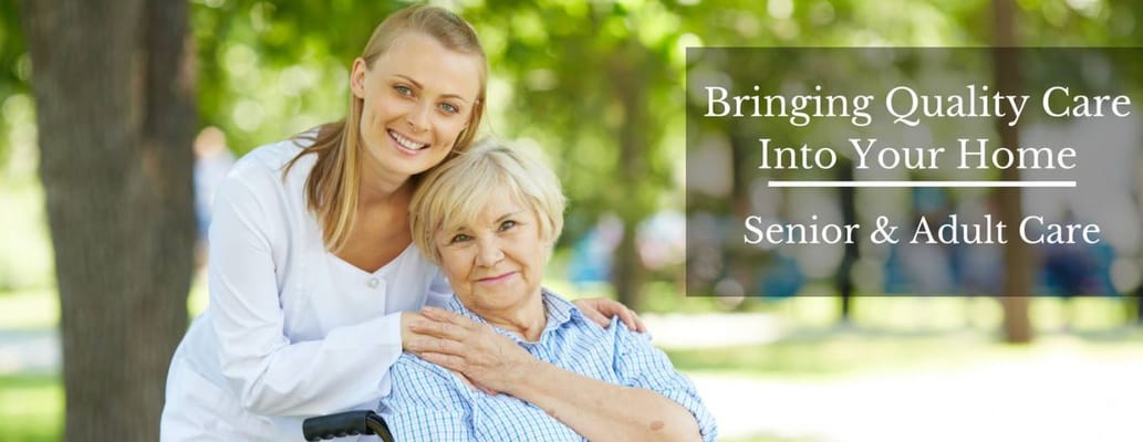 Caregiver assisting an elderly woman outdoors