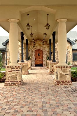 Entrance with large wooden door and stone columns