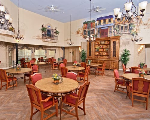 Bright, inviting common area with dining tables