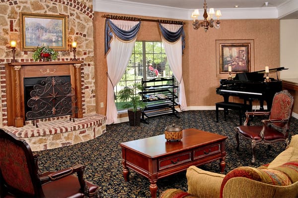 Interior lounge area with a fireplace and piano