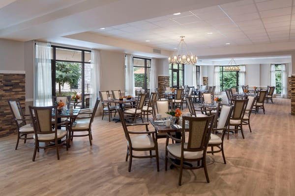 Well-lit dining area with tables set for meals