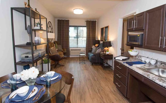 Cozy living space with kitchen, dining table, and comfortable seating