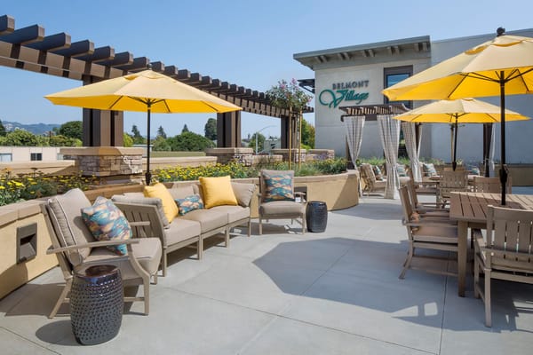 Spacious outdoor patio with yellow umbrellas and comfortable seating