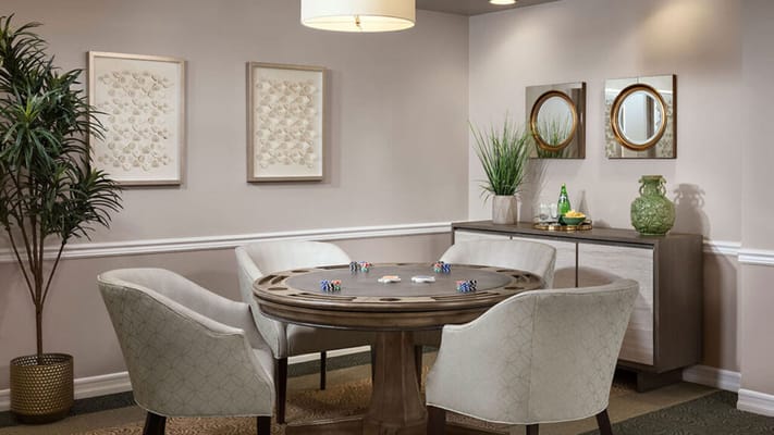 Cozy card room with a round table and comfortable chairs