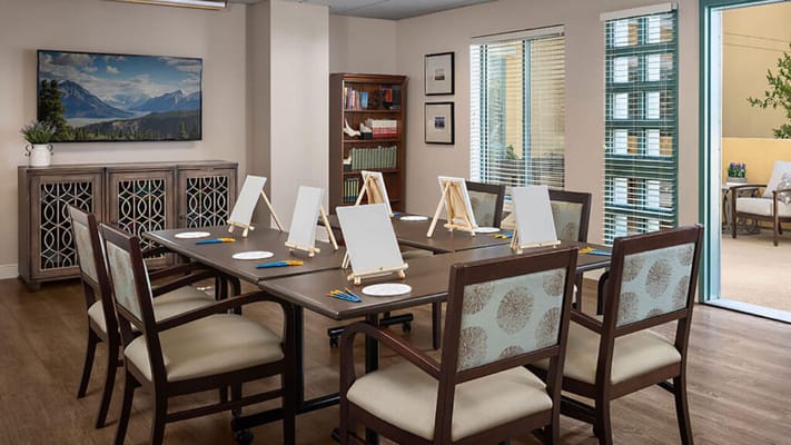 Interior of the art room with empty easels and large windows.