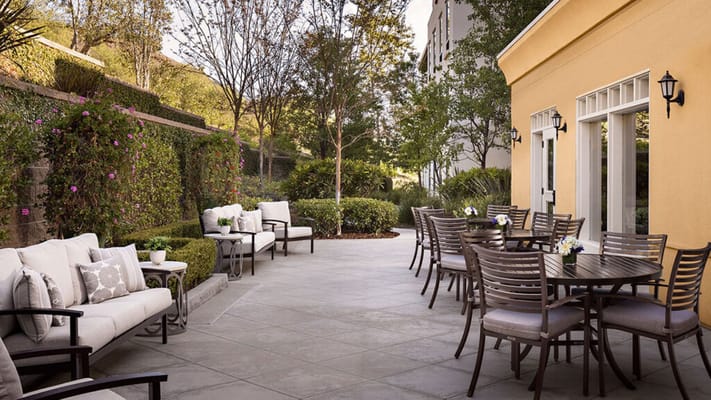 Cozy outdoor patio with seating and floral decorations