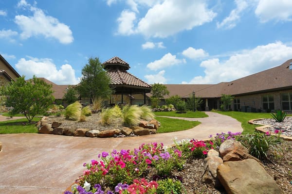 Outdoor garden area with flowers and a gazebo