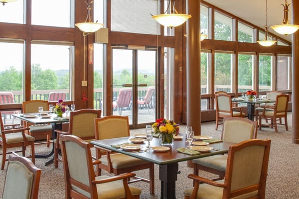 Bright and inviting dining room with tables set for meals