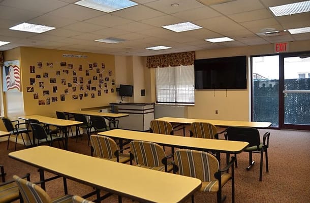 Interior view of the community room with tables and chairs.