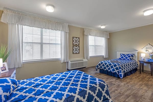 Bright interior of a resident room with two beds