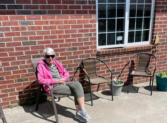 Senior resident relaxing outdoors on a sunny day