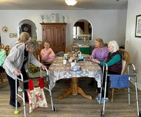 Residents engaging in a group activity around a table