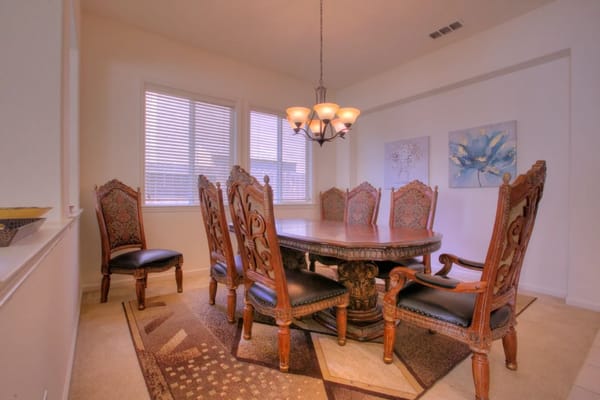 Elegant dining room with a large wooden table and ornate chairs