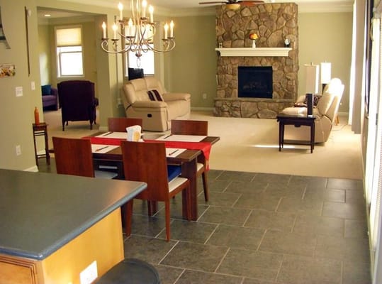 Cozy living room with a stone fireplace and dining area