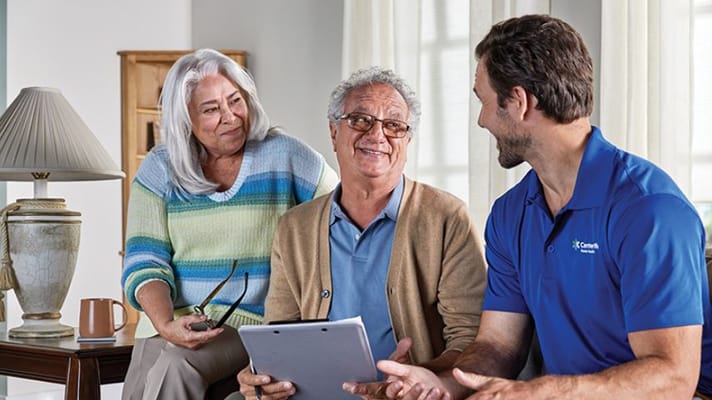 Residents and caregiver engaged in conversation in a common area