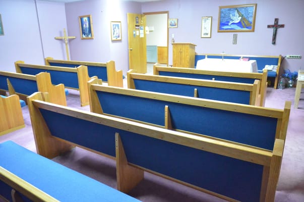 Interior view of the worship area with wooden pews