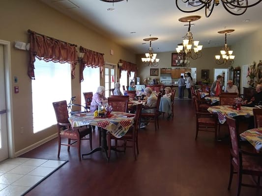 Residents enjoying meals in a dining area