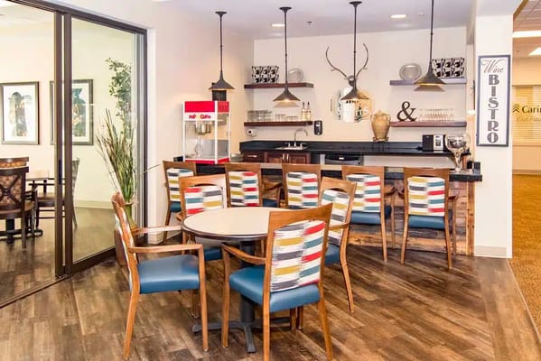Cozy bistro area with seating and a popcorn machine.
