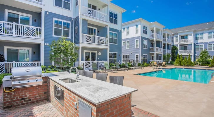 Outdoor view of the facility with a pool and seating area