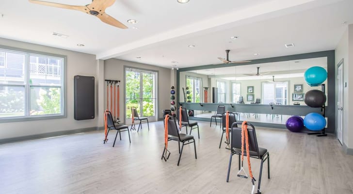 Interior view of an exercise room with chairs and fitness equipment