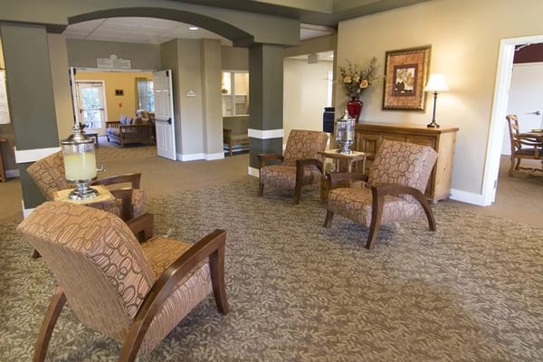 Seating area with two patterned chairs and decorative side table in lobby