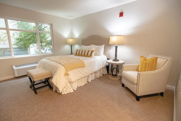 Cozy resident bedroom with warm decor and natural light
