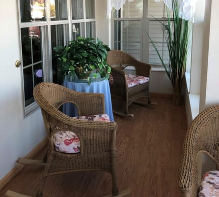 A cozy seating area with wicker chairs in a sunlit room