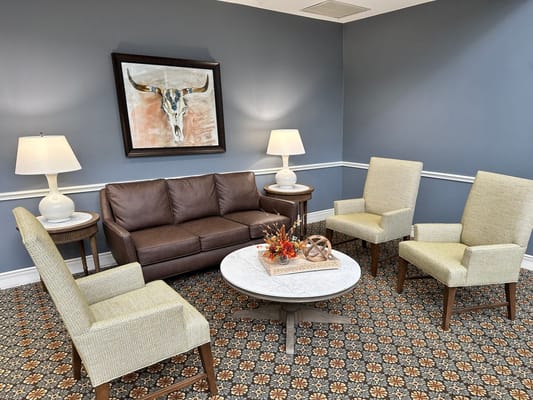 Comfortable living room with a couch, chairs, and a decorative table