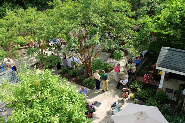 Residents enjoying a community event in the landscaped courtyard