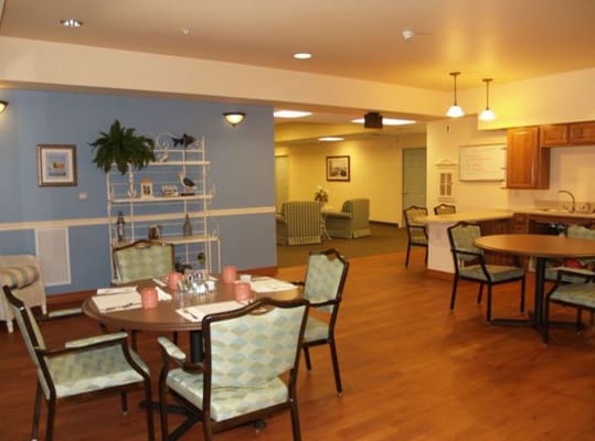 Dining space with tables and chairs in Grand Pines Assisted Living Center