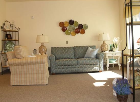 Inviting living room with a patterned couch and decorative wall art