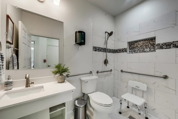 Modern accessible bathroom with shower and grab bars
