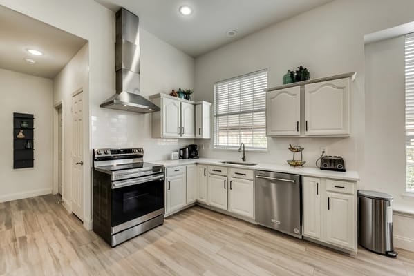 Bright and spacious kitchen with stainless steel appliances and white cabinetry.