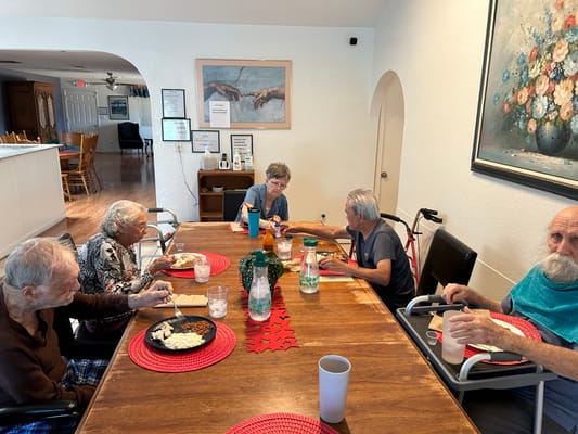 Seniors enjoying a meal together in the dining area.
