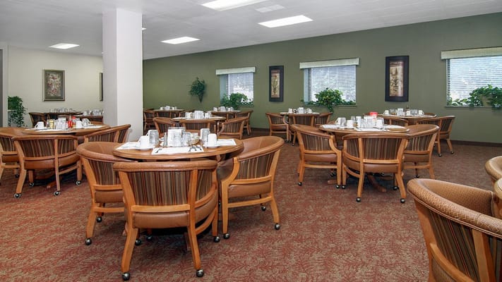 Dining room with round tables and chairs set for meals