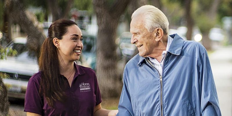 Staff member walking with a resident outdoors
