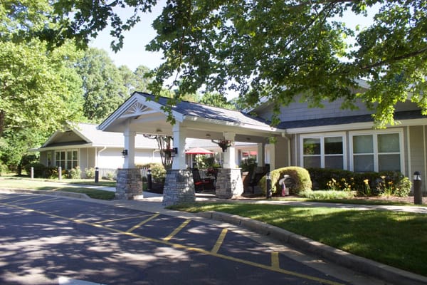 Exterior view of a senior living facility under trees